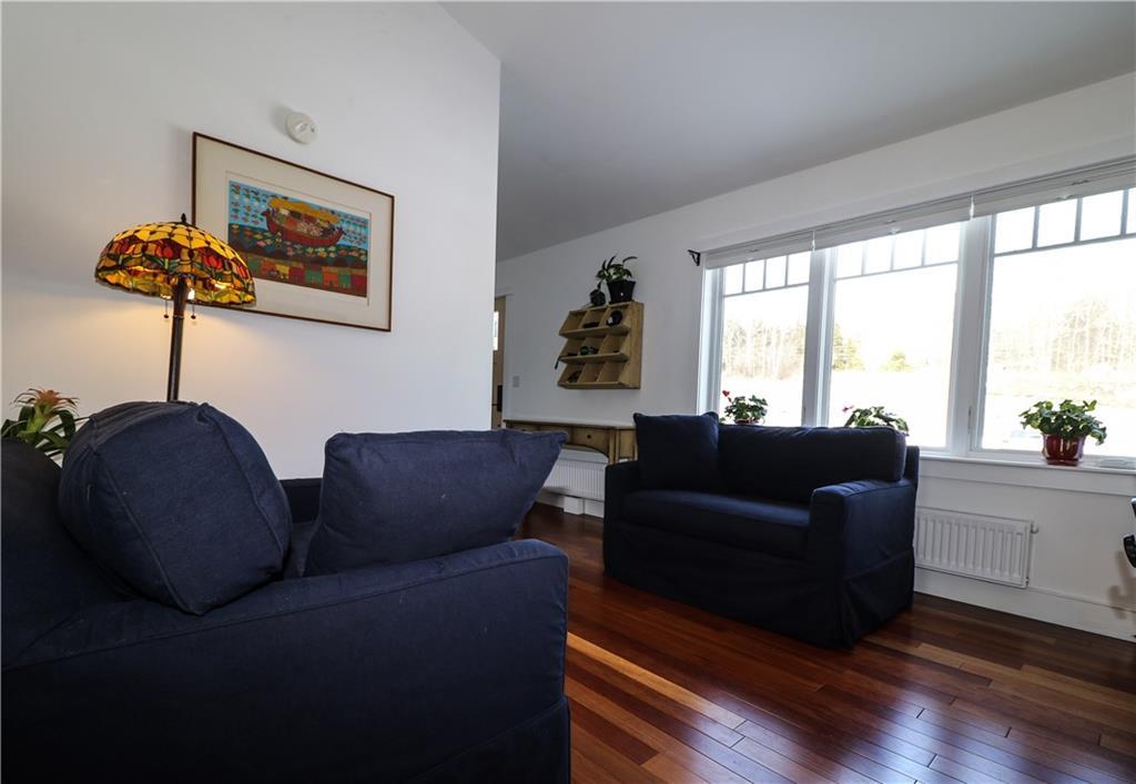 60 Ellsworth Road, Unit 1 Blue Hill, ME 04614 - Photo 6 of 25 Living room with large windows.