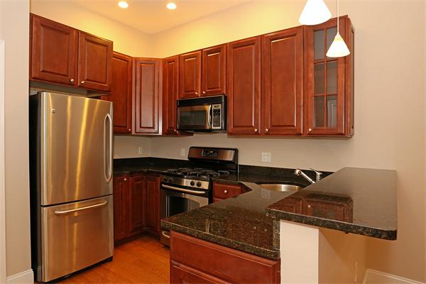 655 East 2nd Street, Unit 209 Boston, MA 02127 - Photo 2 of 16 a kitchen with stainless steel appliances granite countertop a refrigerator stove and microwave