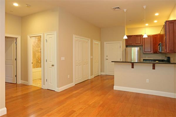 655 East 2nd Street, Unit 209 Boston, MA 02127 - Photo 5 of 16 a view of a kitchen with wooden floor