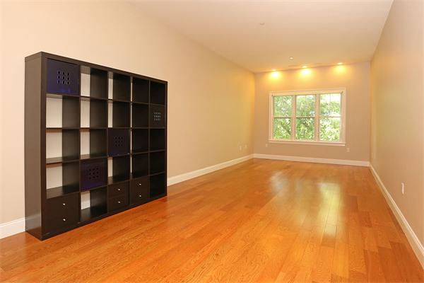 655 East 2nd Street, Unit 209 Boston, MA 02127 - Photo 6 of 16 a view of an empty room with a window and wooden floor