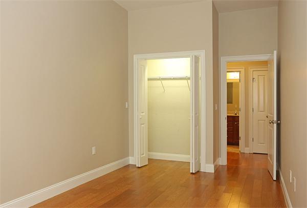 655 East 2nd Street, Unit 209 Boston, MA 02127 - Photo 7 of 16 an empty room with wooden floor and closet