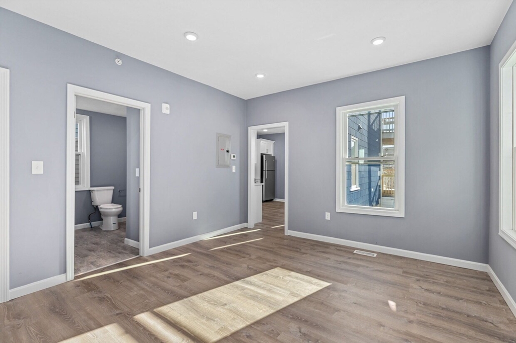 167 Lexington Street, Unit 167 Boston, MA 02128 - Photo 14 of 34 a view of a big room with wooden floor and a bathroom