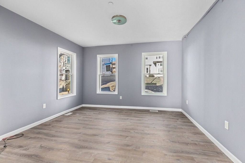 167 Lexington Street, Unit 167 Boston, MA 02128 - Photo 16 of 34 a view of room with window and hardwood floor