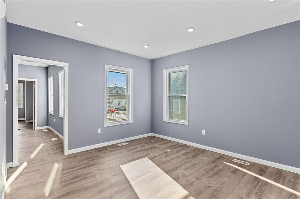 167 Lexington Street, Unit 167 Boston, MA 02128 - Photo 18 of 34 an empty room with windows