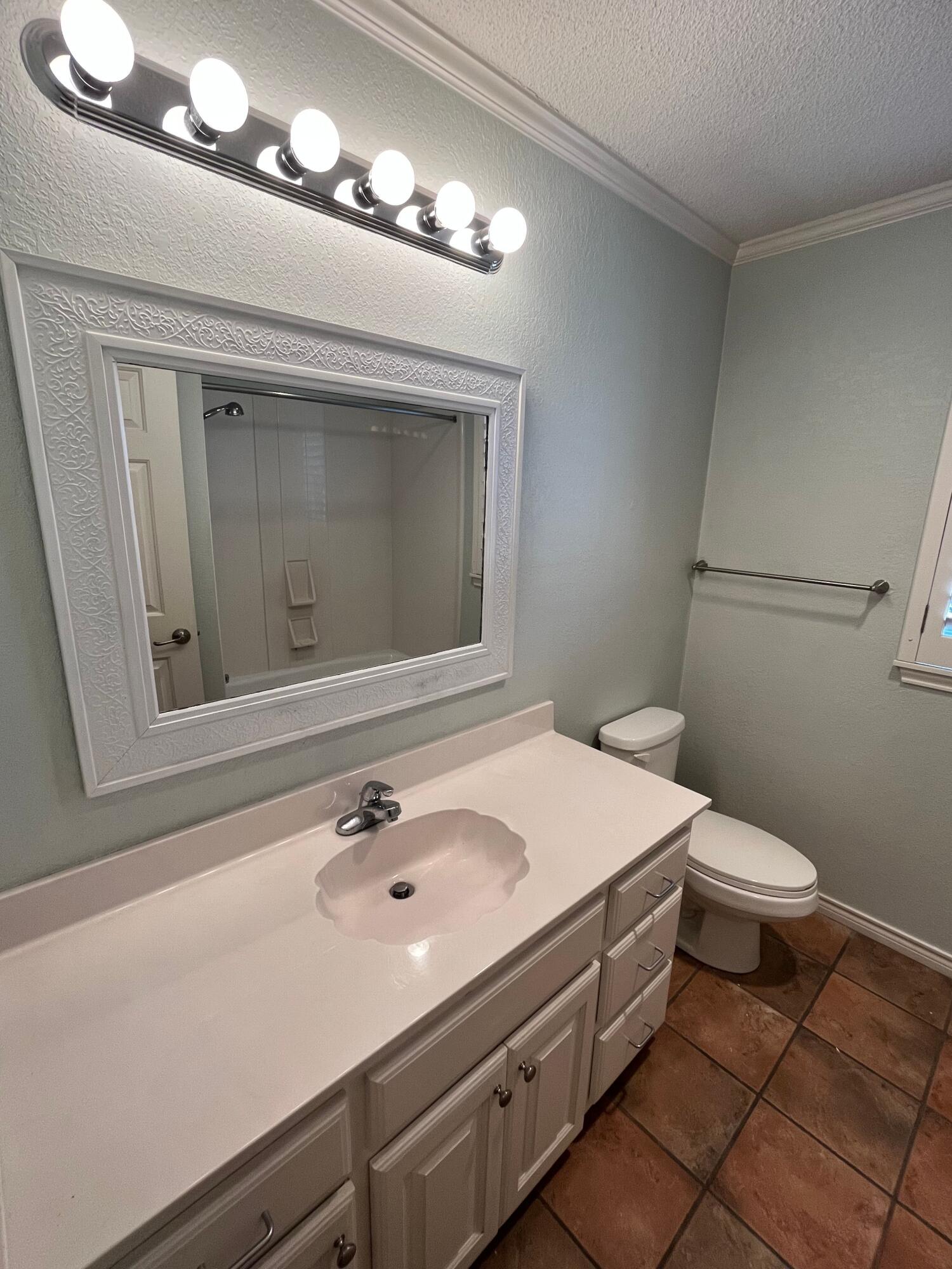 10602 Wayne Avenue Lubbock, TX 79424 - Photo 11 of 17 a bathroom with a sink and a mirror