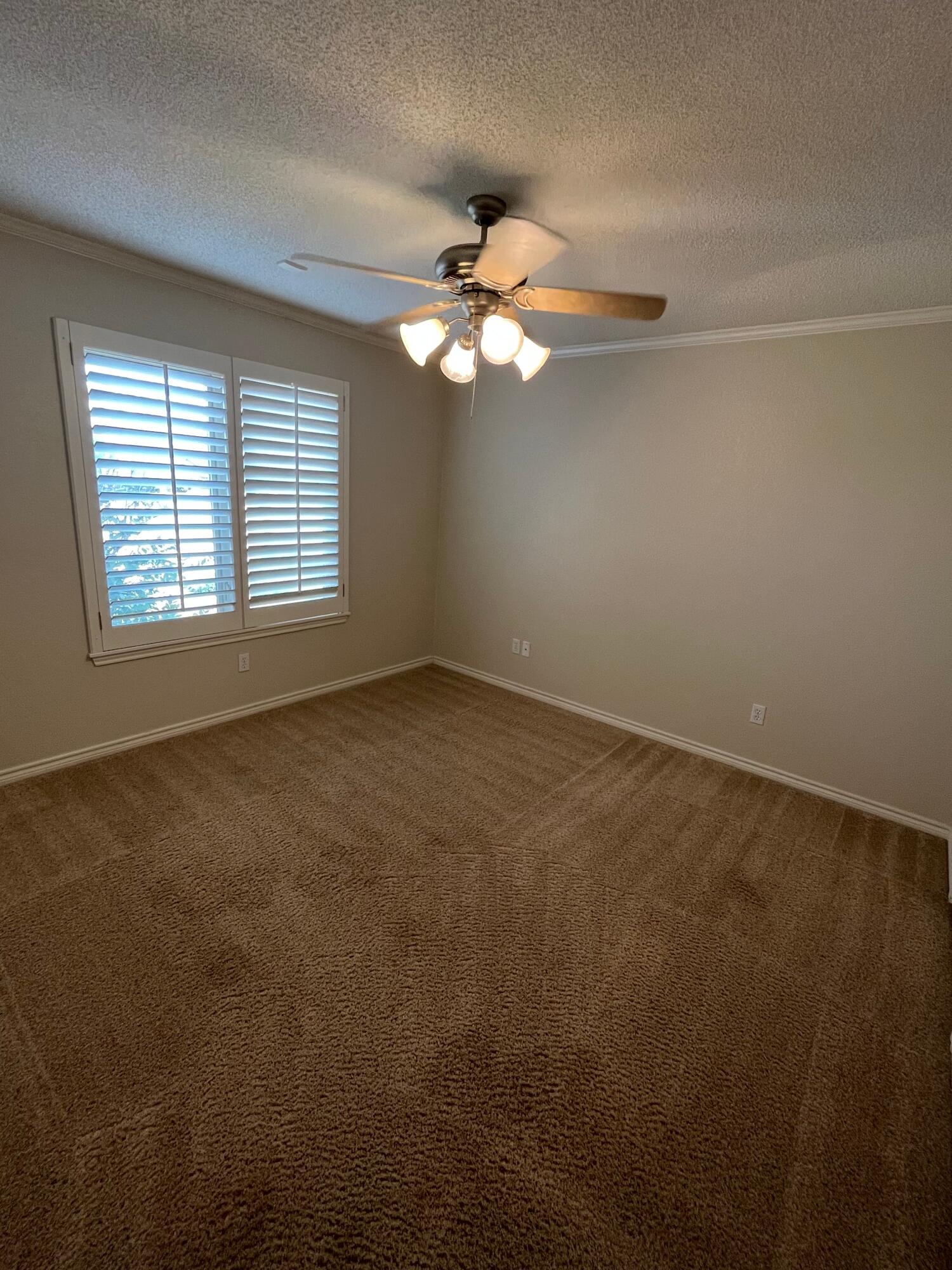 10602 Wayne Avenue Lubbock, TX 79424 - Photo 13 of 17 an empty room with a window and a fan