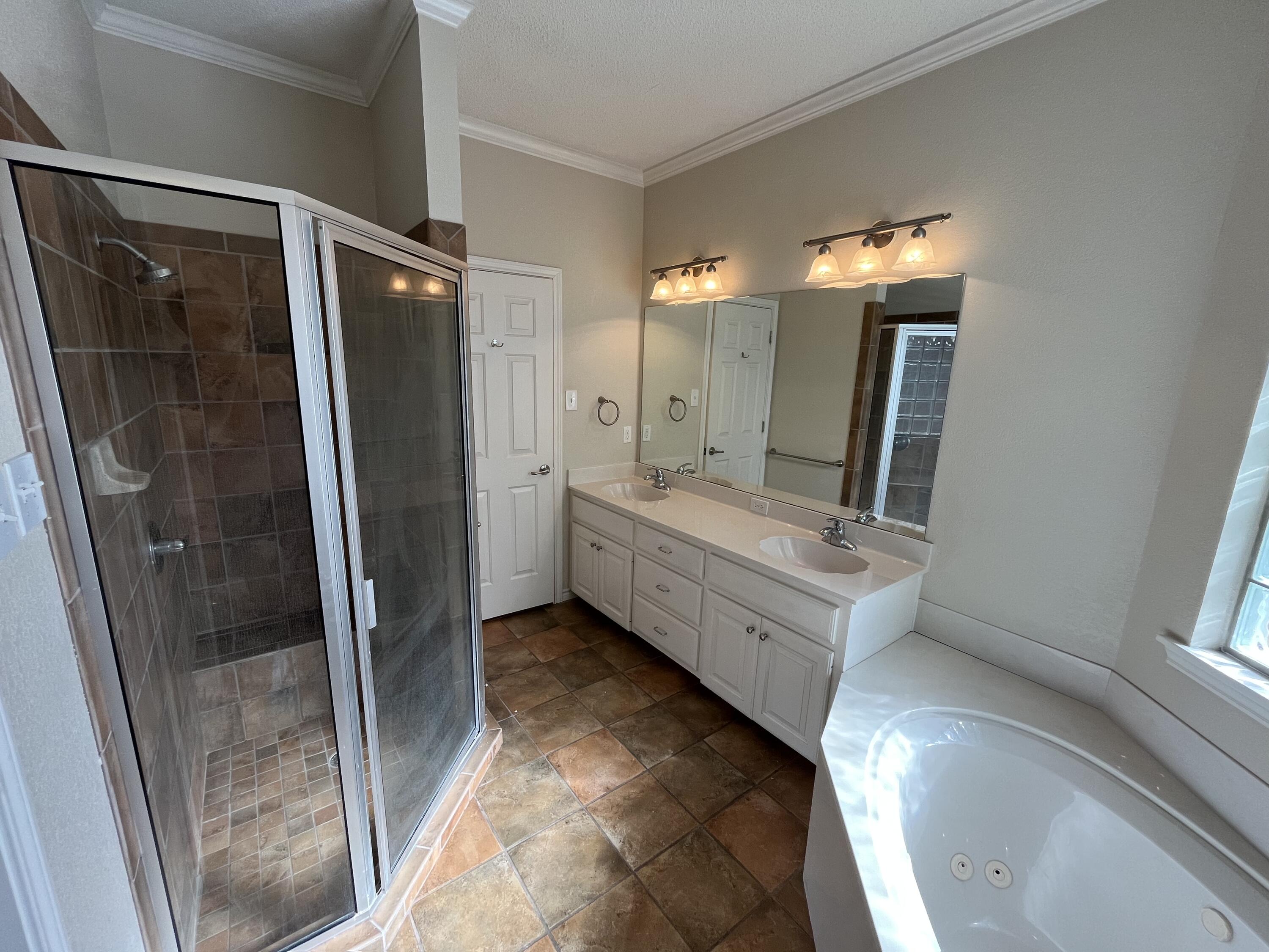 10602 Wayne Avenue Lubbock, TX 79424 - Photo 7 of 17 a bathroom with a tub sink and mirror