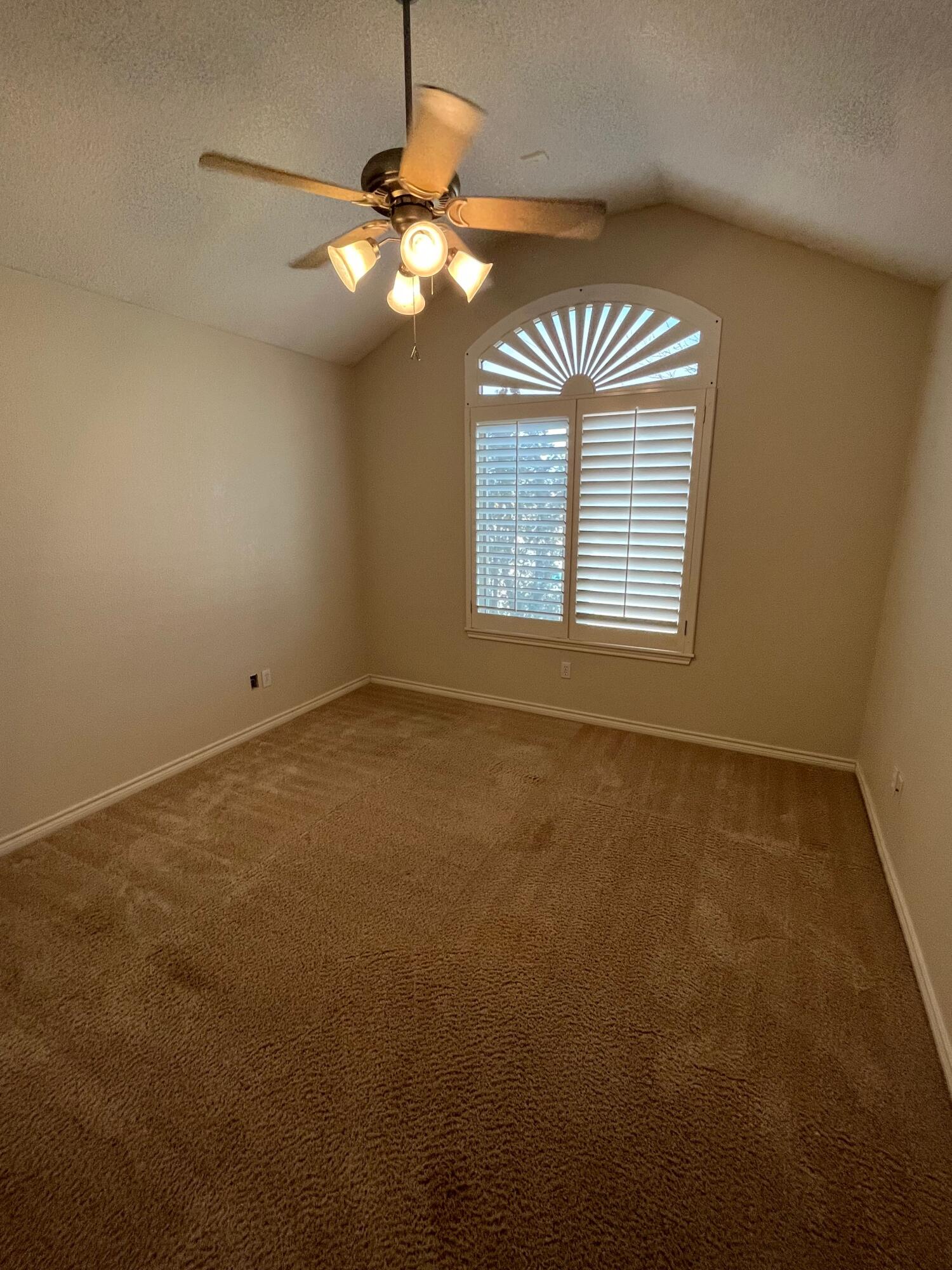 10602 Wayne Avenue Lubbock, TX 79424 - Photo 10 of 17 a view of an empty room with a chandelier