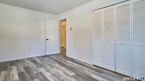 a view of empty room with a window and ceiling fan