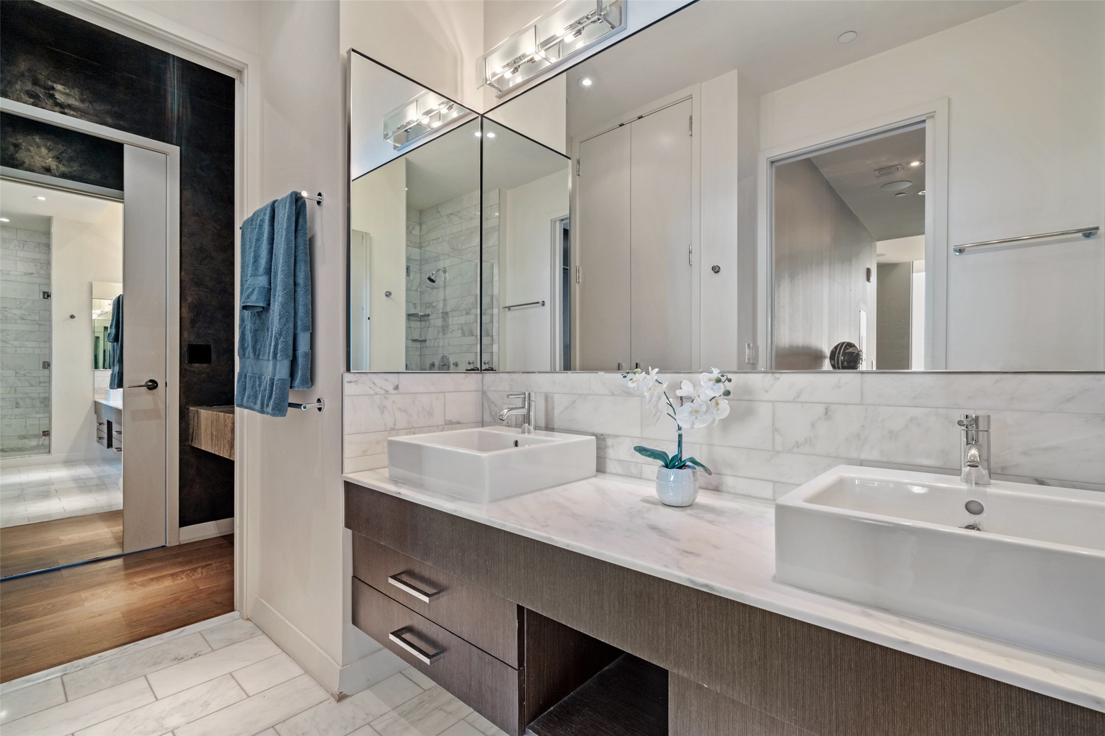 210 Lavaca Street, Unit 2203 Austin, TX 78701 - Photo 20 of 30 Full bathroom featuring double vanity, decorative backsplash, and a shower stall