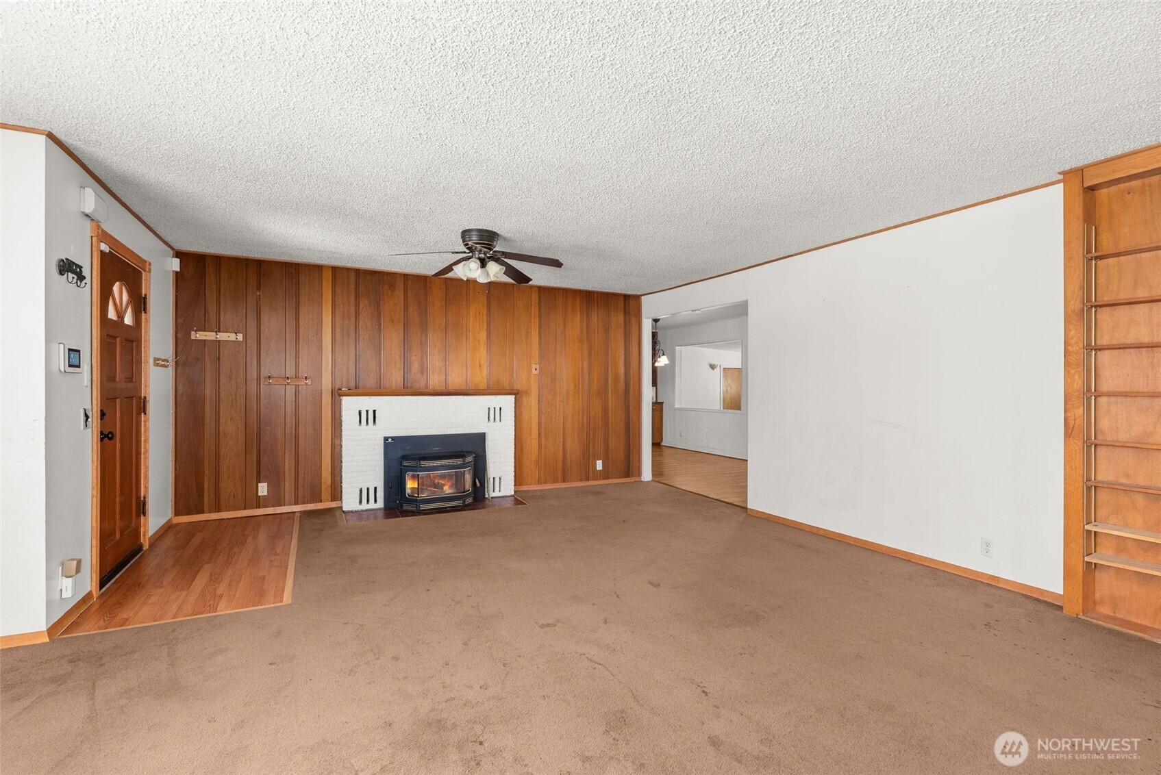 402 North 10th Street Elma, WA 98541 - Photo 11 of 35 a view of an empty room with a fireplace and a window