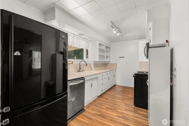 a kitchen with stainless steel appliances granite countertop a refrigerator and a sink