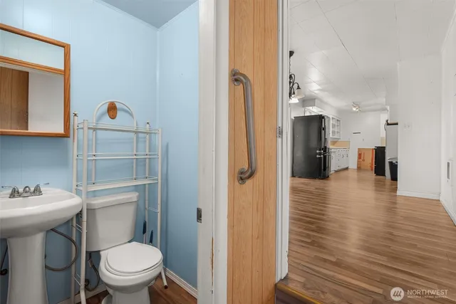 a very nice looking room with a wooden floor and a toilet