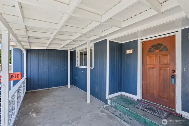 an empty room with closet and entryway