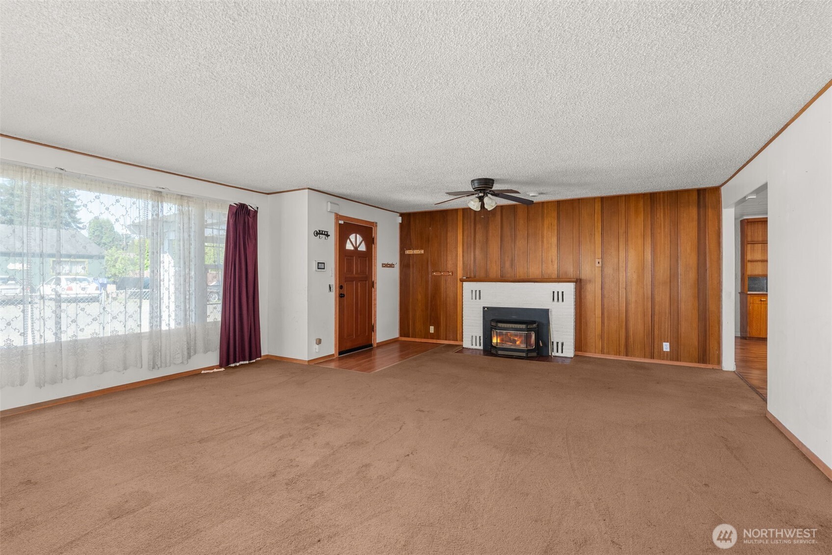 402 North 10th Street Elma, WA 98541 - Photo 7 of 35 a view of an empty room with a fireplace and a window