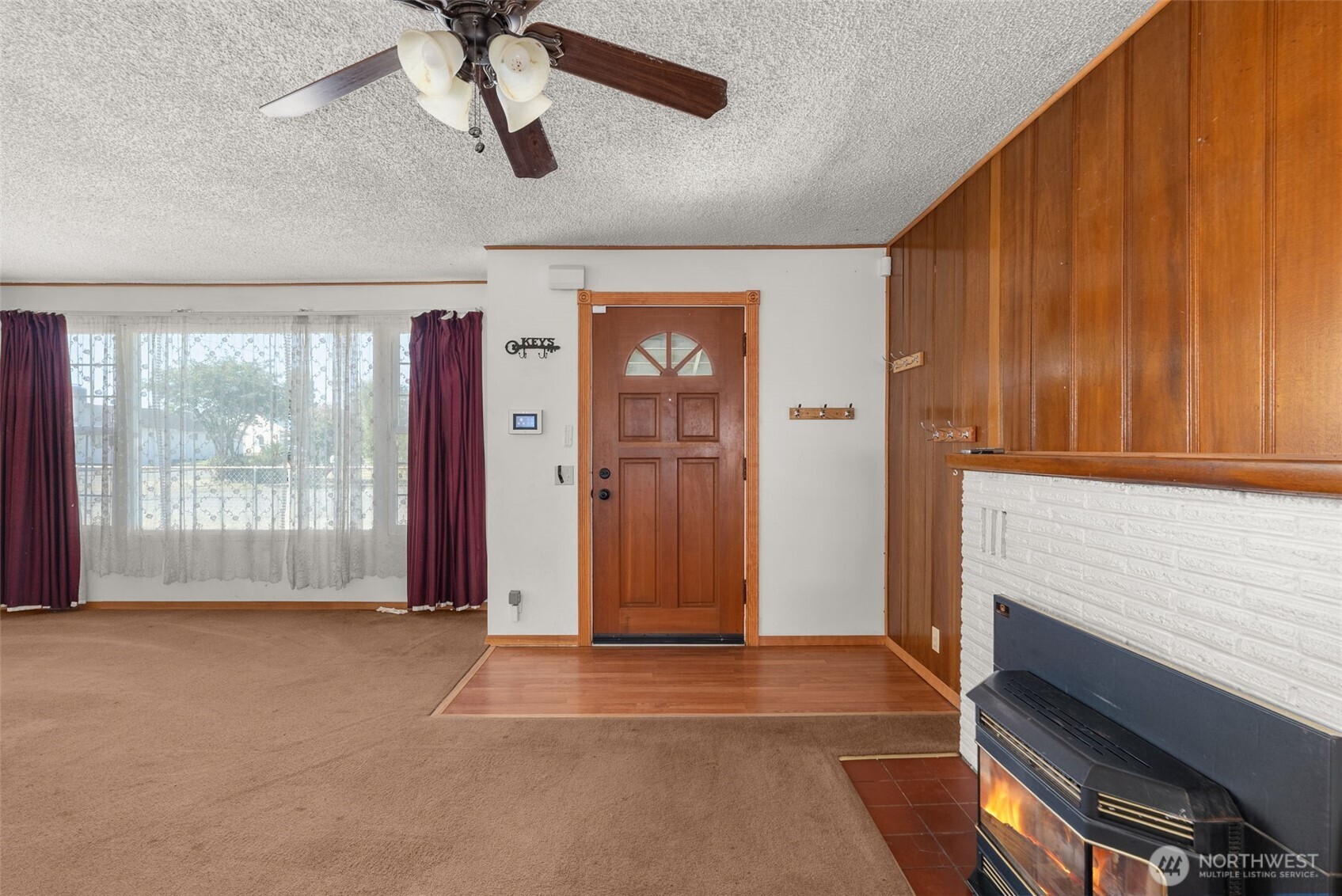 402 North 10th Street Elma, WA 98541 - Photo 9 of 35 a view of empty room with wooden floor and fan