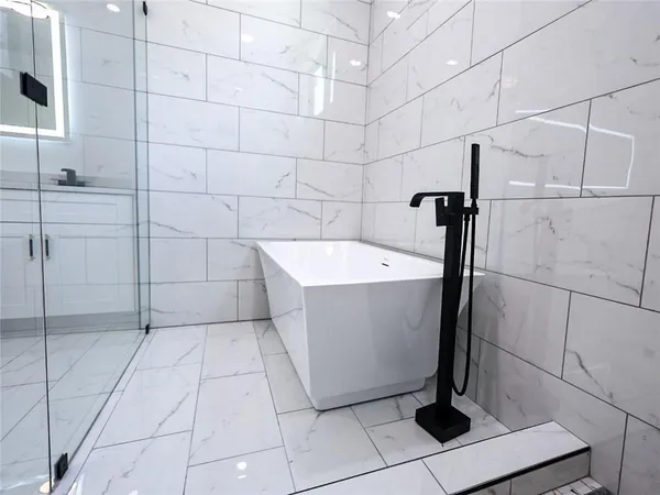 a bathroom with a shower and a sink