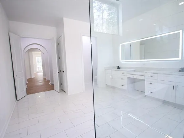 a bathroom with a granite countertop sink toilet and shower
