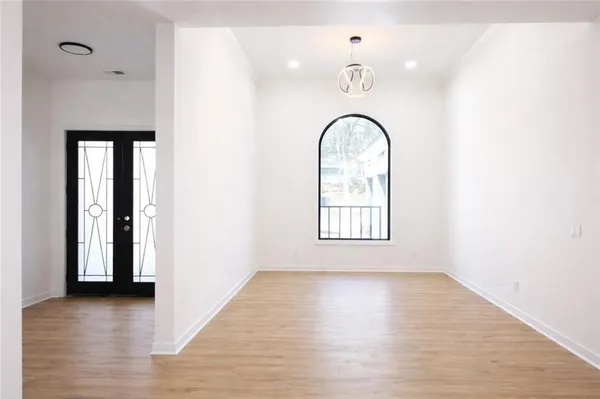 a view of a livingroom with wooden floor and window