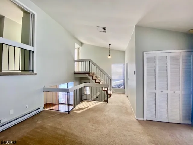 an empty room with windows and stairs