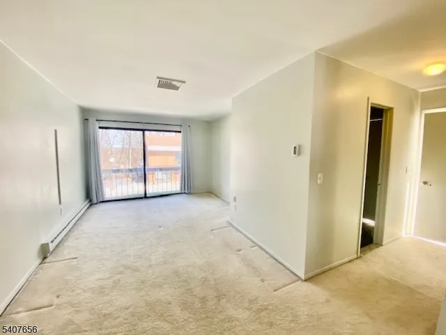 a view of an empty room and a window