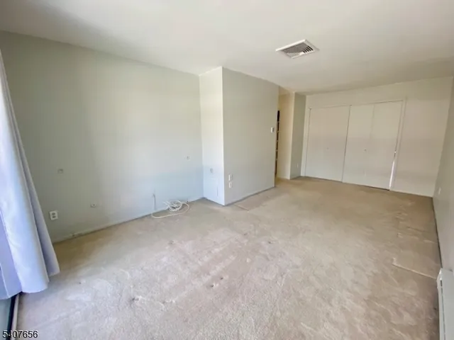 a view of an empty room and entryway