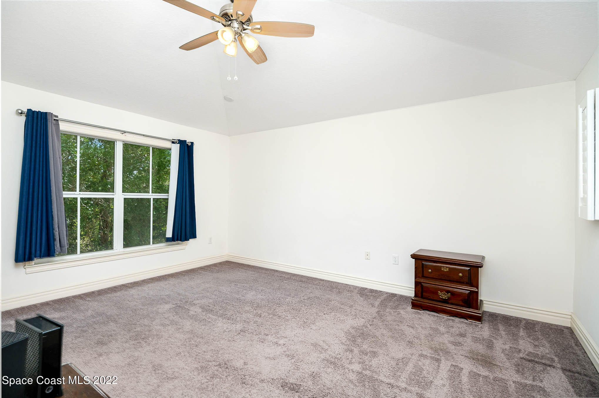 634 Cedar Side Circle Northeast Palm Bay, FL 32905 - Photo 13 of 24 an empty room with windows and ceiling fan