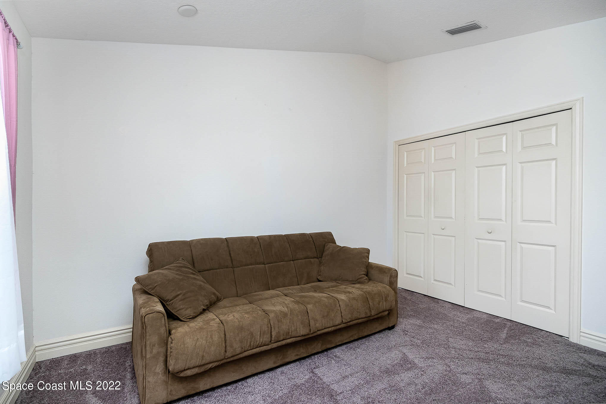 634 Cedar Side Circle Northeast Palm Bay, FL 32905 - Photo 19 of 24 a living room with furniture and a rug