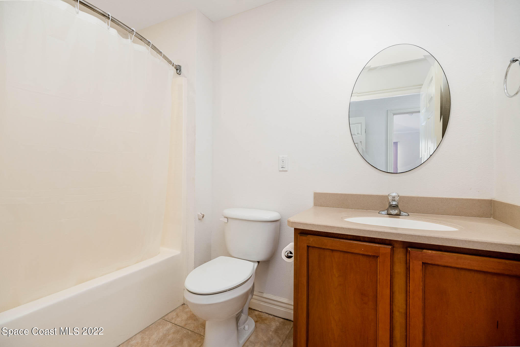 634 Cedar Side Circle Northeast Palm Bay, FL 32905 - Photo 20 of 24 a bathroom with a sink toilet and a mirror