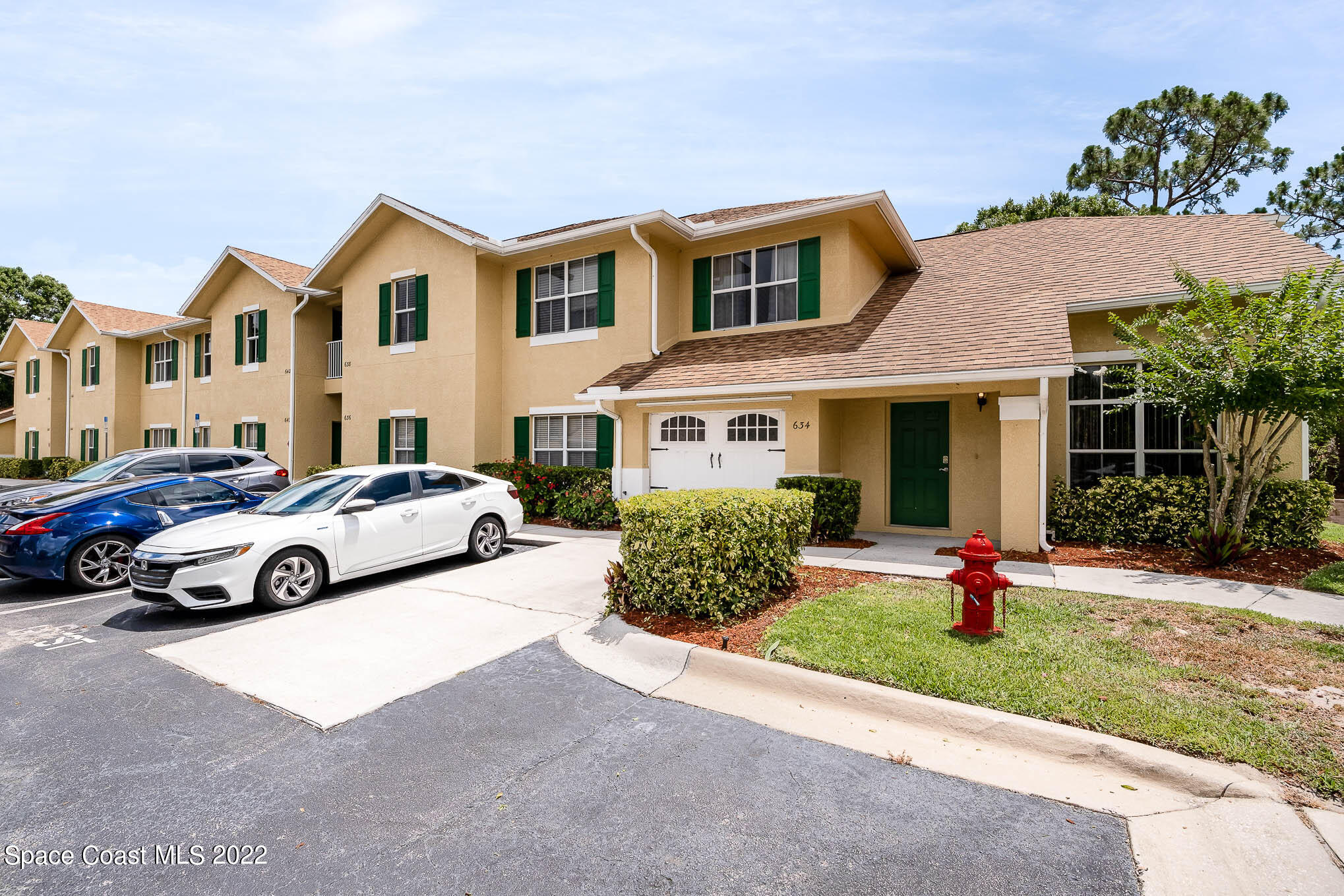 634 Cedar Side Circle Northeast Palm Bay, FL 32905 - Photo 23 of 24 a view of a white house and a yard in front of it
