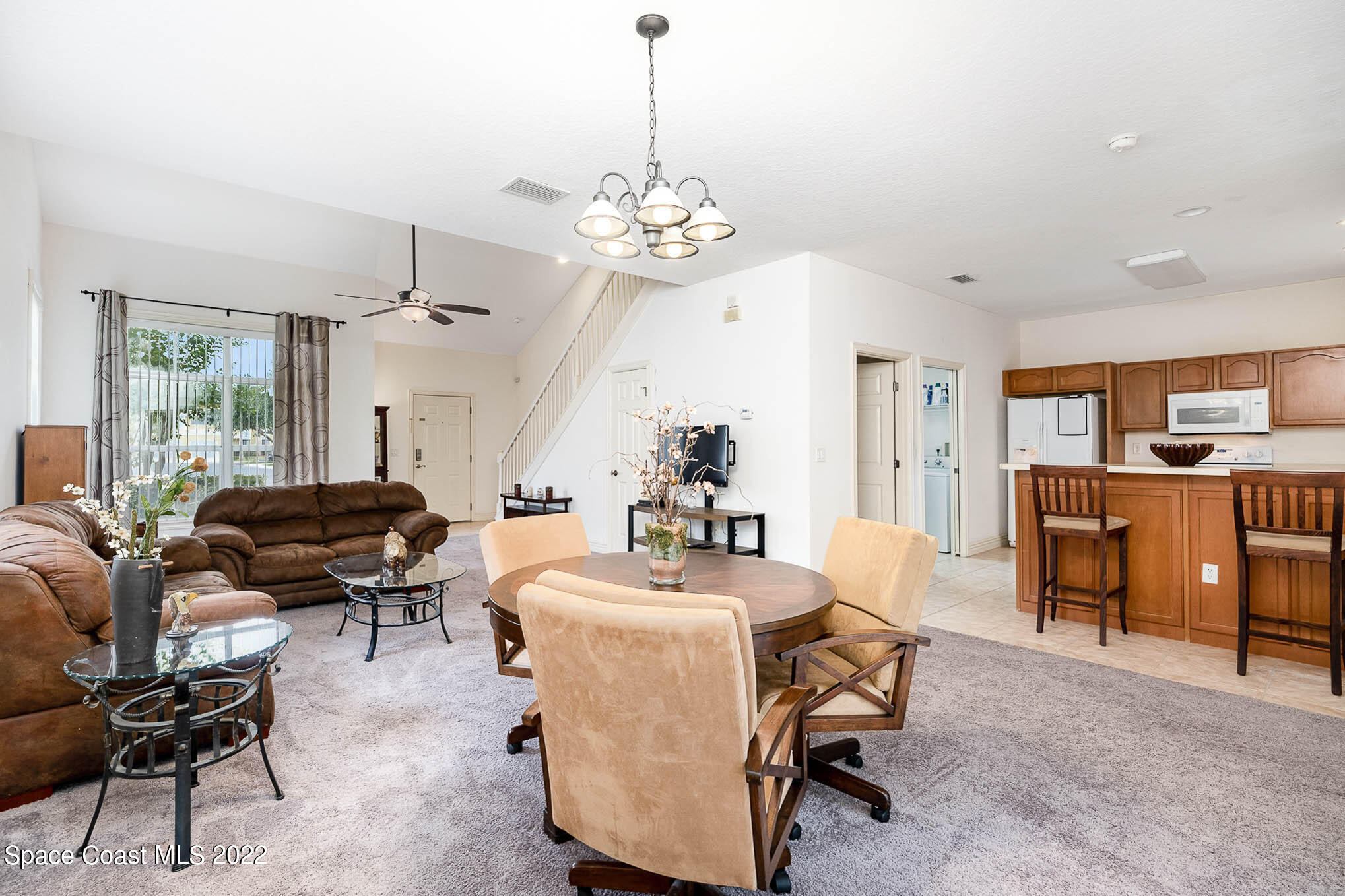 634 Cedar Side Circle Northeast Palm Bay, FL 32905 - Photo 6 of 24 a view of a livingroom with furniture and a chandelier