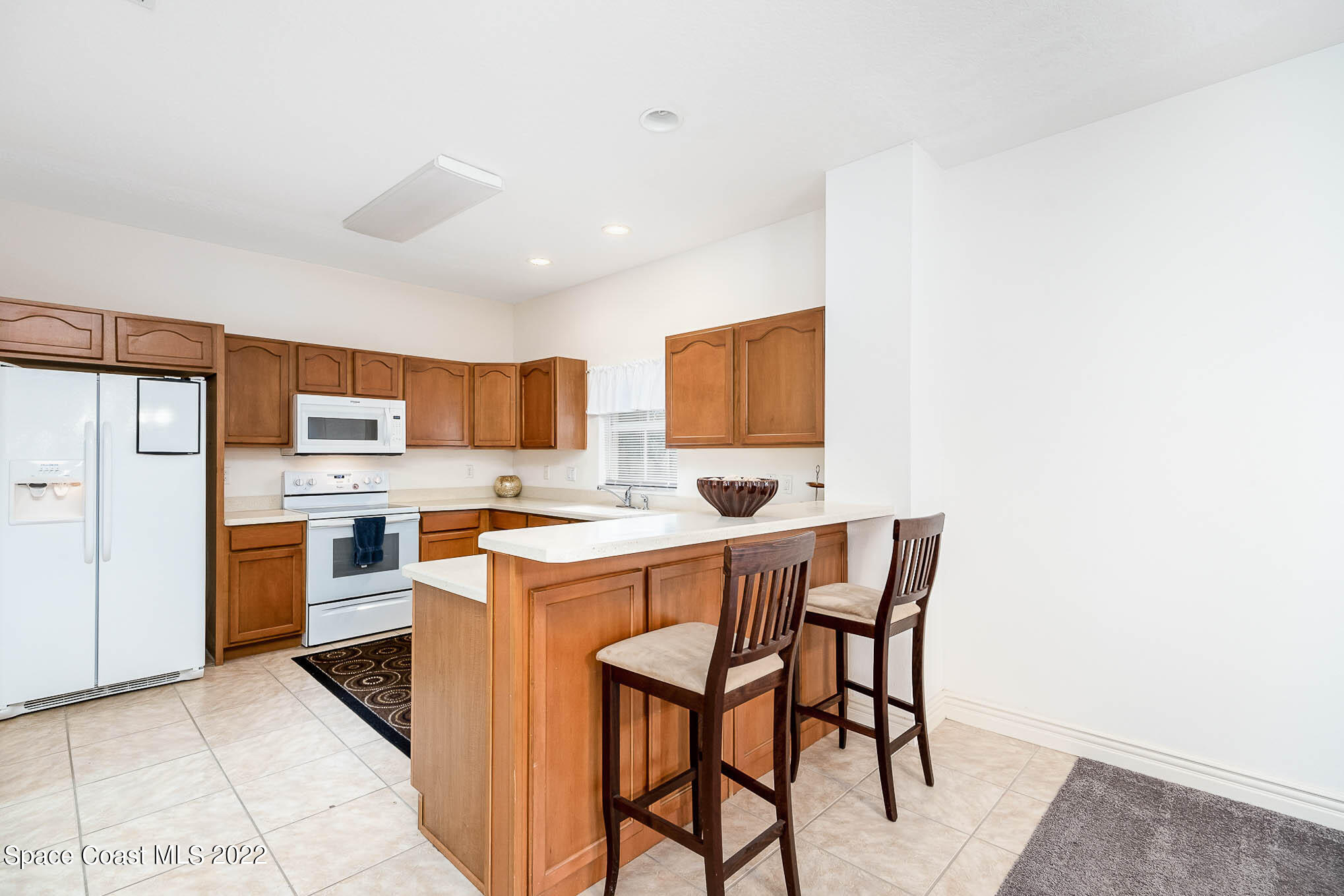 634 Cedar Side Circle Northeast Palm Bay, FL 32905 - Photo 7 of 24 a kitchen that has a dining table chairs stainless steel appliances and cabinets