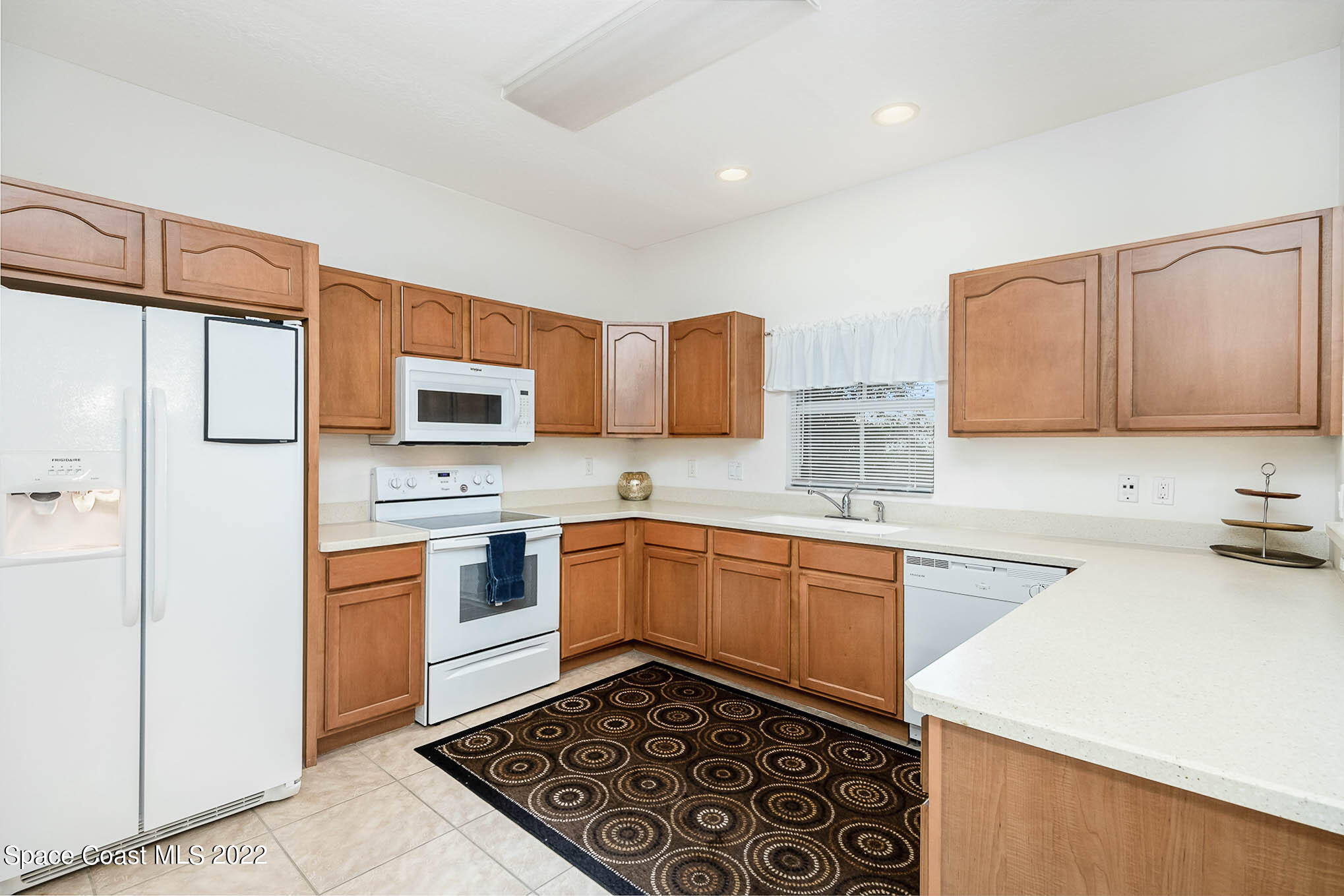 634 Cedar Side Circle Northeast Palm Bay, FL 32905 - Photo 8 of 24 a kitchen with stainless steel appliances a refrigerator sink stove microwave and cabinets