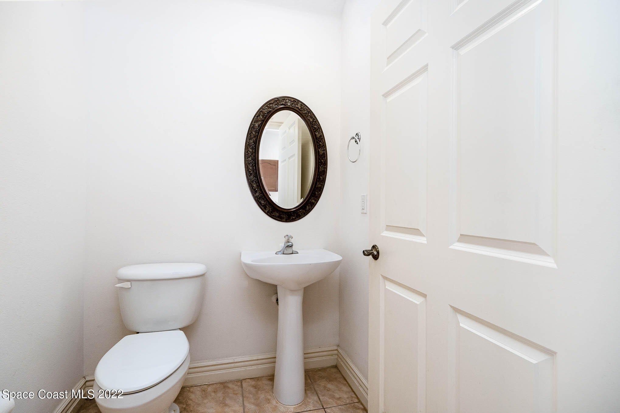 634 Cedar Side Circle Northeast Palm Bay, FL 32905 - Photo 10 of 24 a bathroom with a toilet a sink and a mirror