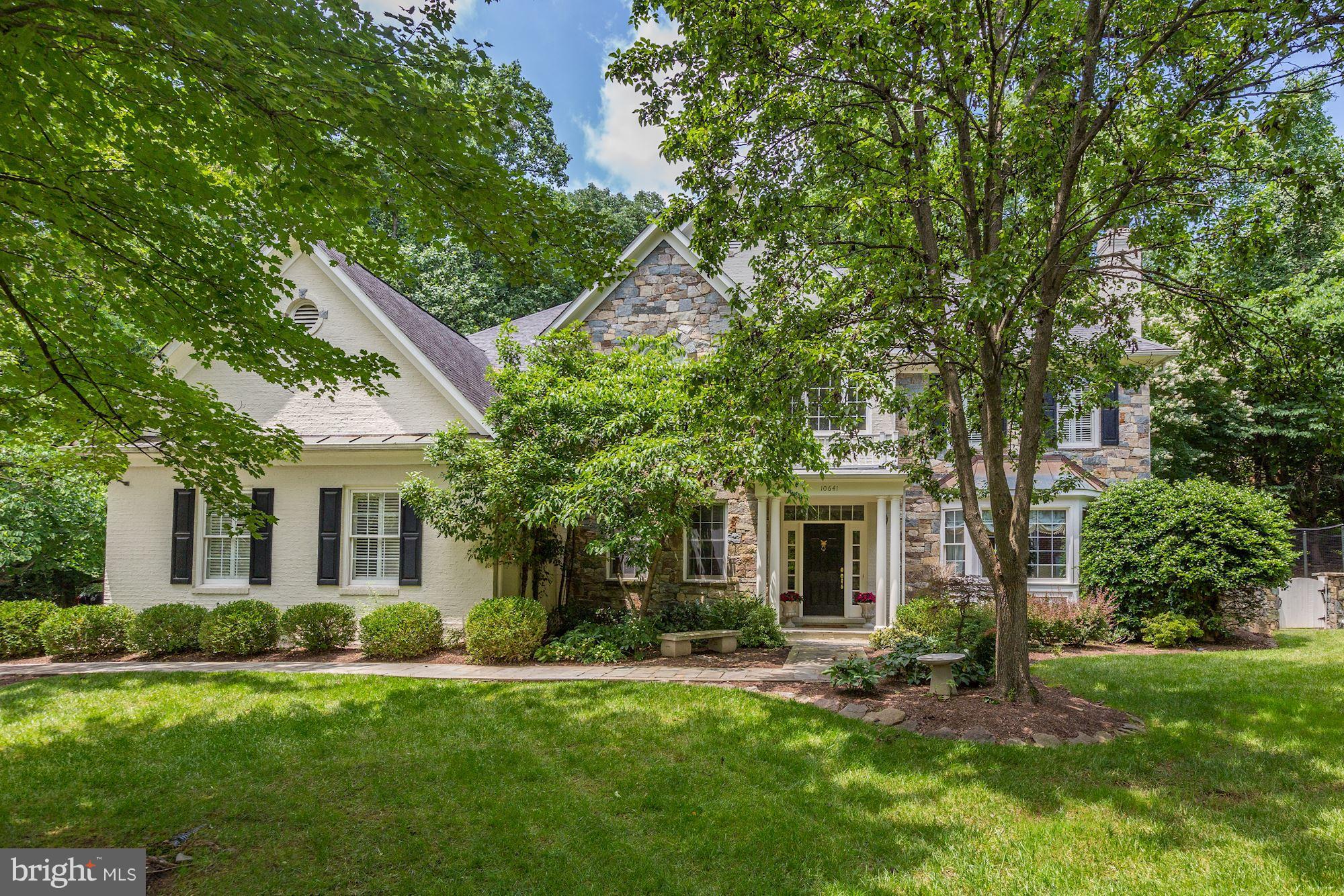 10641 Macarthur Boulevard Potomac, MD 20854 - Photo 1 of 1 a front view of a house with a garden