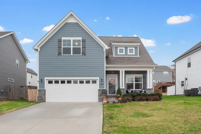 a view of a house with a yard and front view of a house