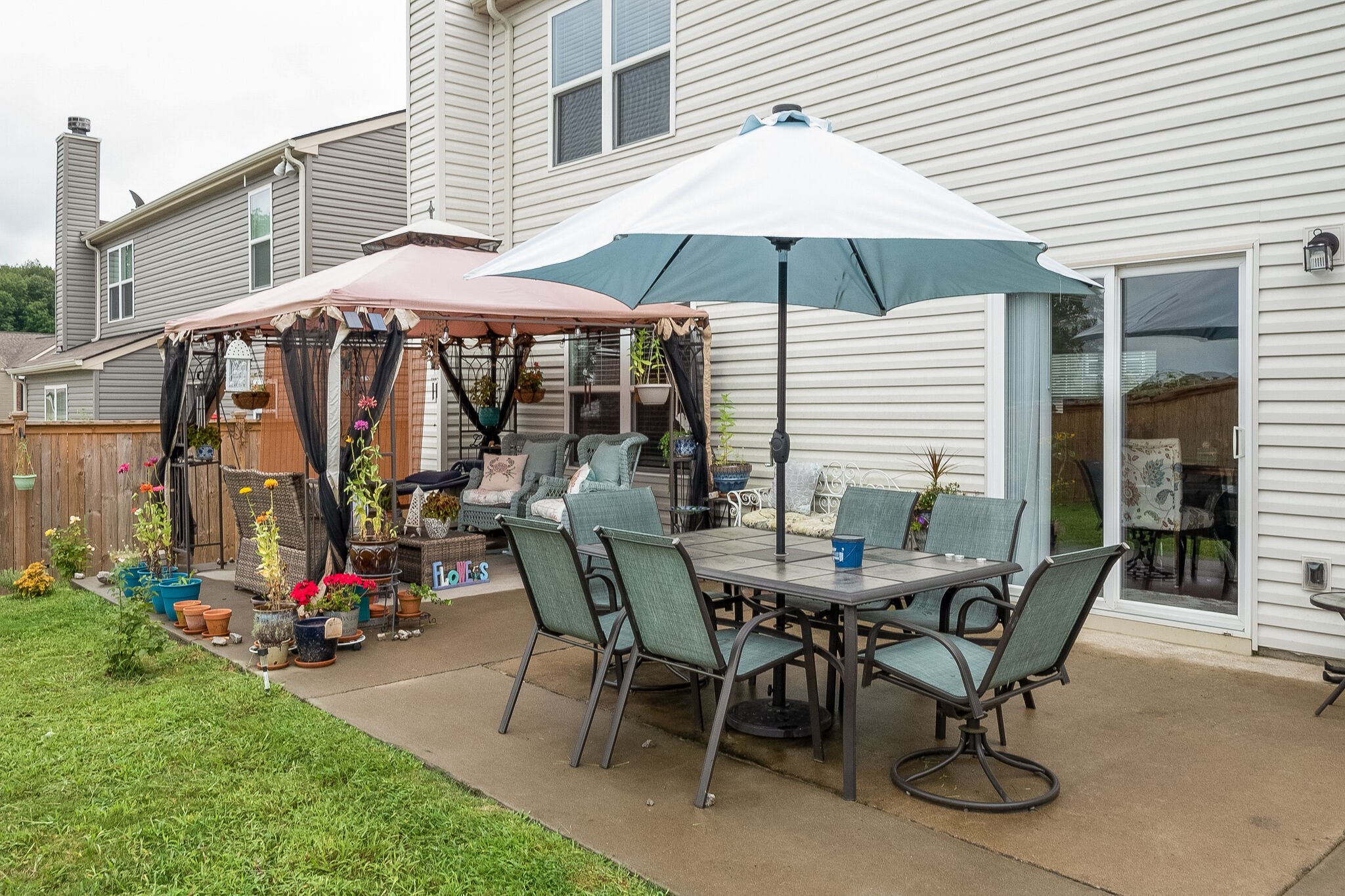 1463 Old Stone Road Lebanon, TN 37087 - Photo 27 of 32 a view of a patio with table and chairs under an umbrella
