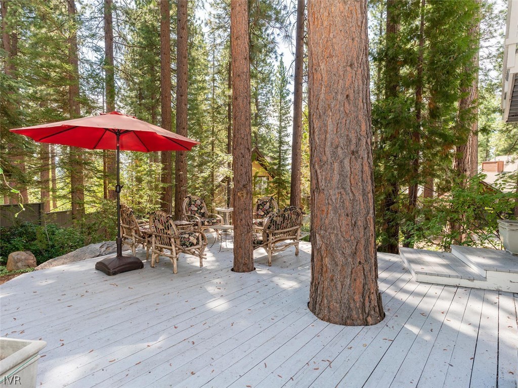 338 Woodridge Way Incline Village, NV 89451 - Photo 11 of 16 a view of a deck with a table and chairs under an umbrella