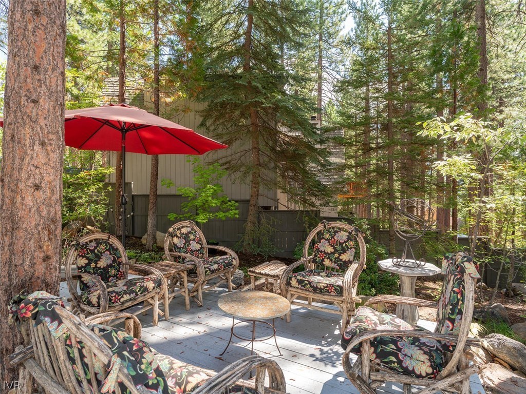 338 Woodridge Way Incline Village, NV 89451 - Photo 13 of 16 a view of a patio with lawn chairs under an umbrella