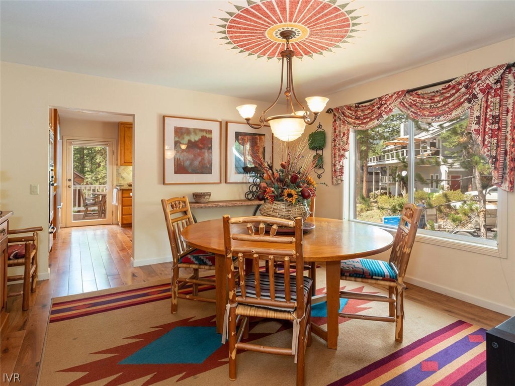 338 Woodridge Way Incline Village, NV 89451 - Photo 4 of 16 a view of a dining room with furniture a chandelier and wooden floor