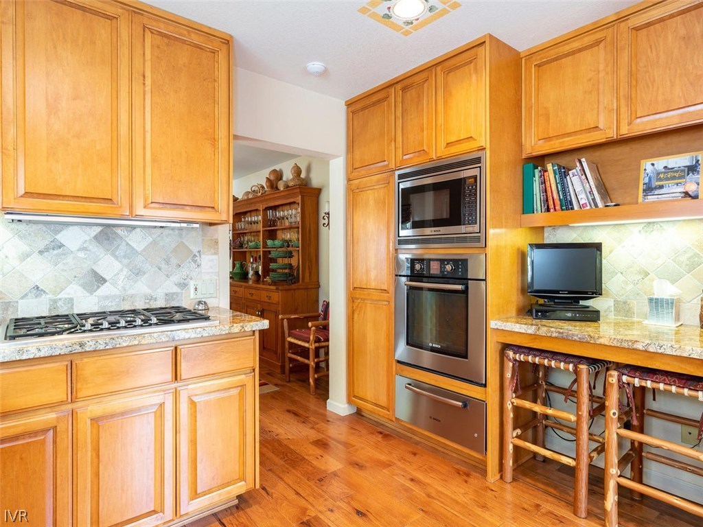 338 Woodridge Way Incline Village, NV 89451 - Photo 6 of 16 a kitchen with stainless steel appliances a stove microwave and cabinets