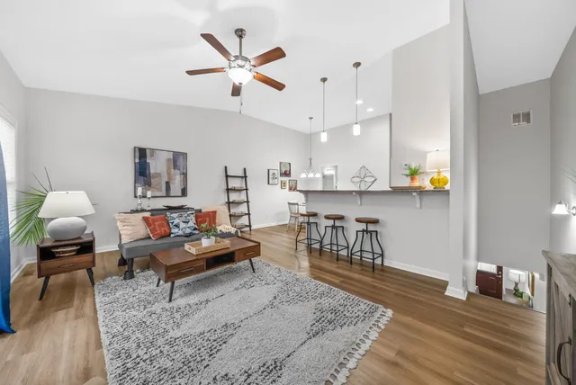 a living room with furniture and wooden floor