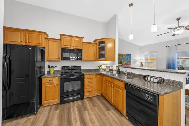 a bathroom with a sink a toilet a mirror a vanity and shower