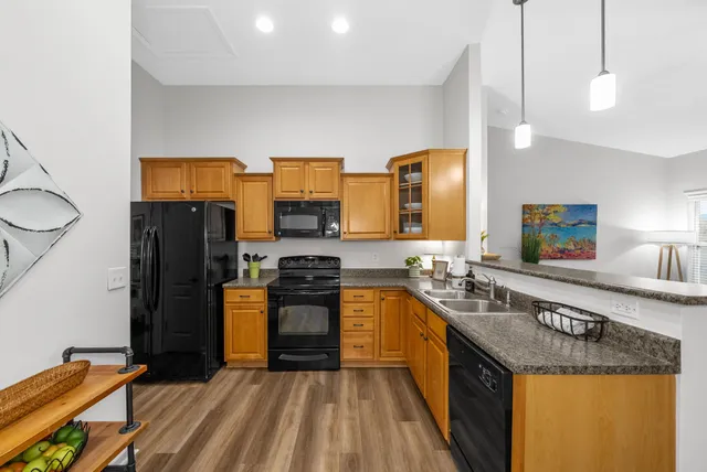 a view of a patio with table and chairs with wooden floor and fence