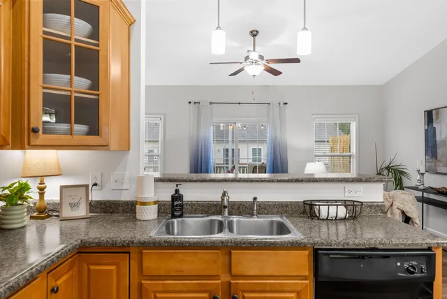a kitchen with stainless steel appliances granite countertop a sink a stove and cabinets