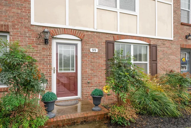 a front view of a house with garden and porch