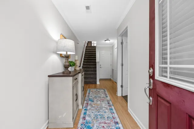 a kitchen with a dining table and chairs with wooden floor