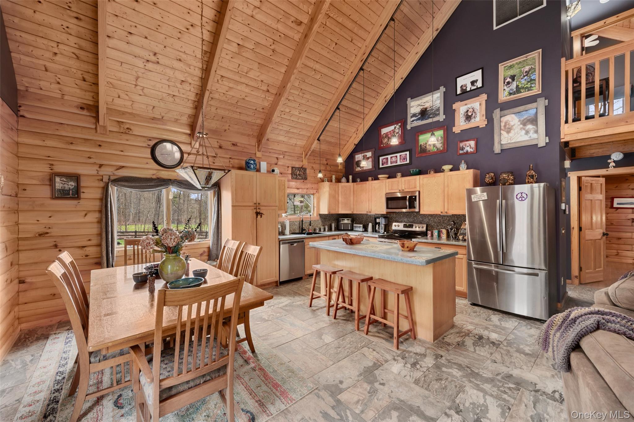 198 Hortontown Road Hopewell Junction, NY 12533 - Photo 6 of 36 a kitchen with stainless steel appliances kitchen island granite countertop a refrigerator a stove a dining table and chairs with wooden floor