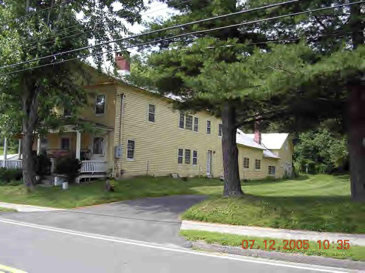60 South Main Road Otis, MA 01253 - Photo 3 of 6 a front view of a house with a yard and trees