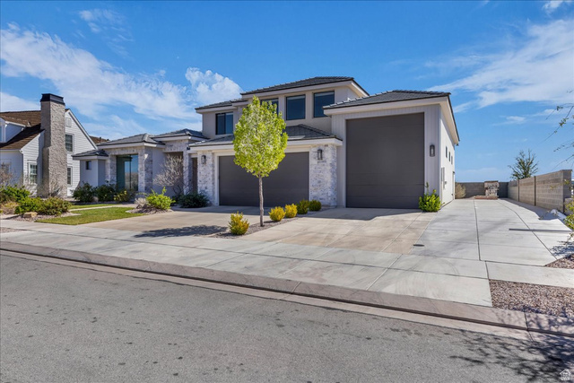 404 North Marsala Way St. George, UT 84770 - Photo 3 of 26 Prairie-style home with concrete driveway, a tiled roof, and stucco siding